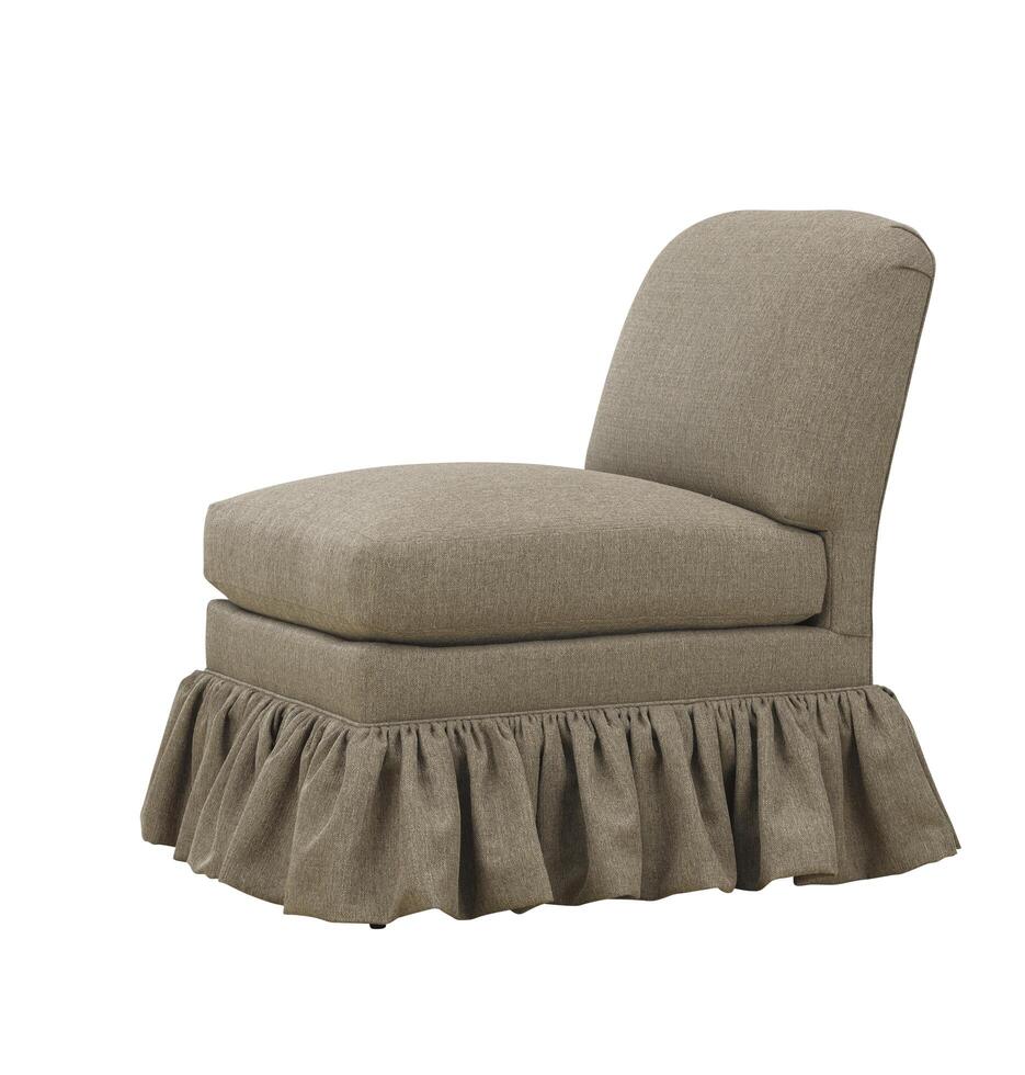 Elegant upholstered chair with skirt detail isolated on a white background photo