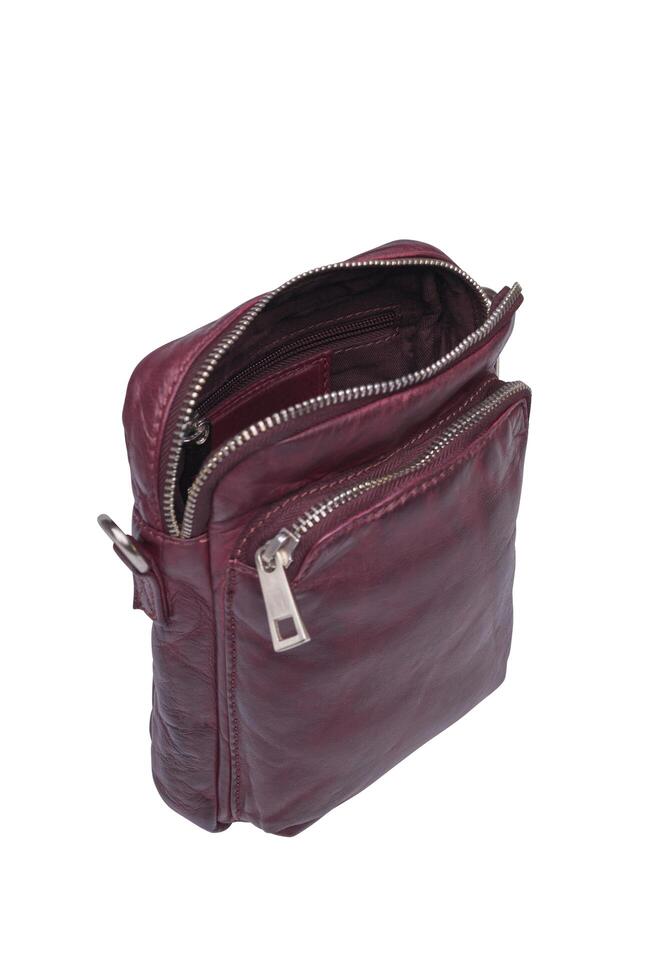 Open maroon leather crossbody bag with silver zippers studio shot photo