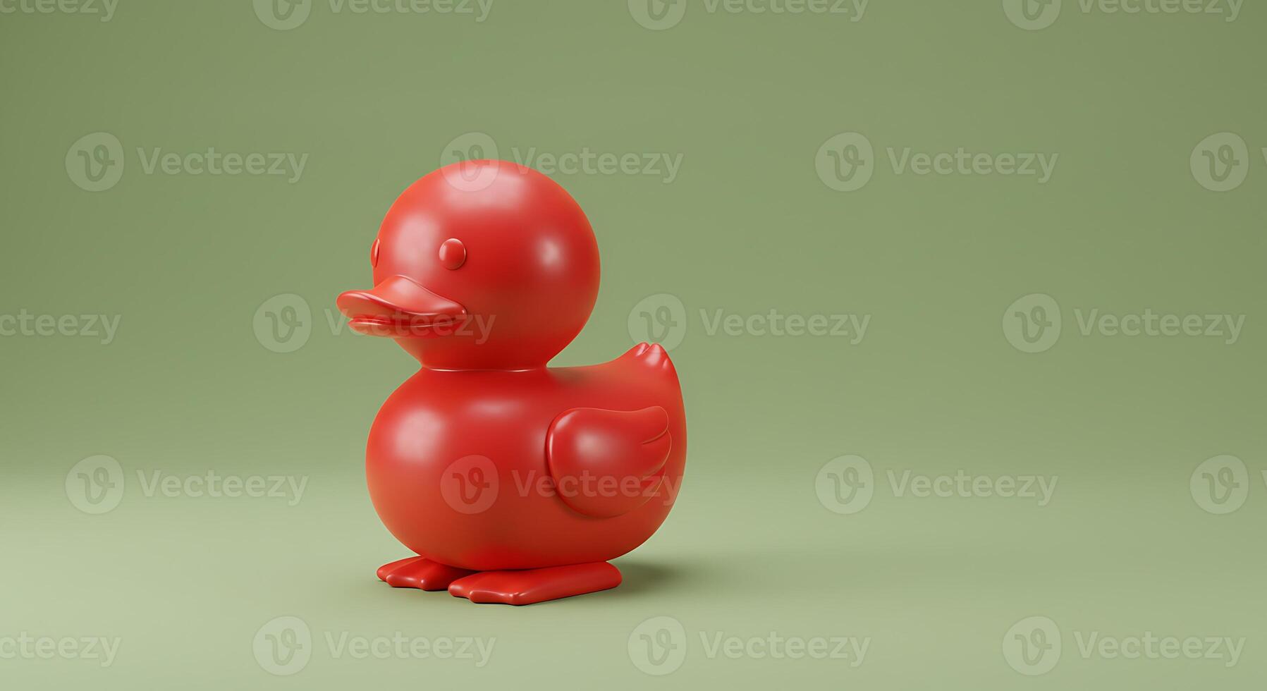 A red duck toy on a green background photo