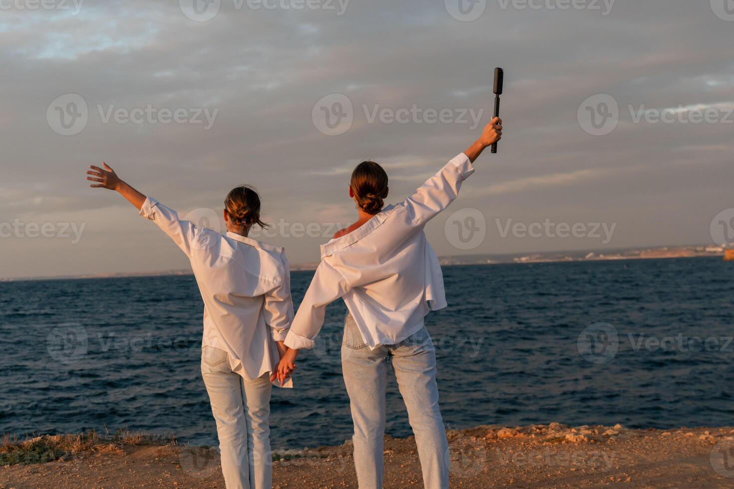 Couple Beach Sunset Arms Raised Joyful Moment photo
