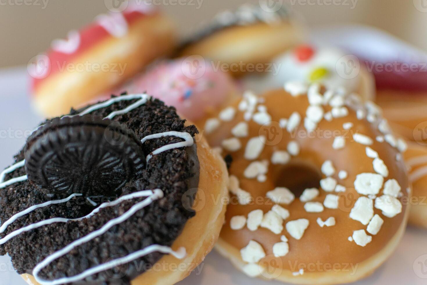 a close up image of a variety of flavoured doughnuts bokeh image photo
