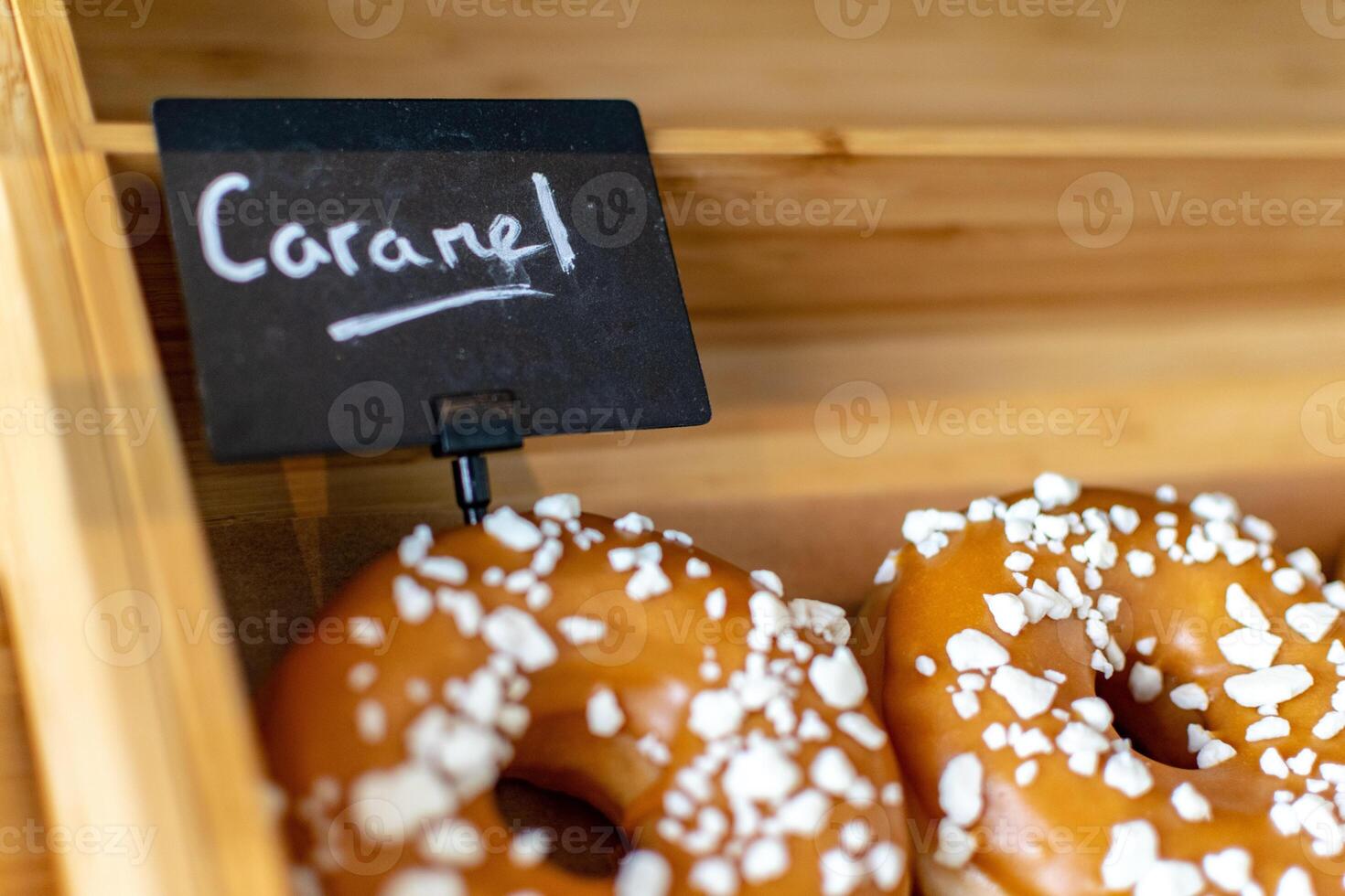 a close up image of a caramel doughnuts at a bakery photo