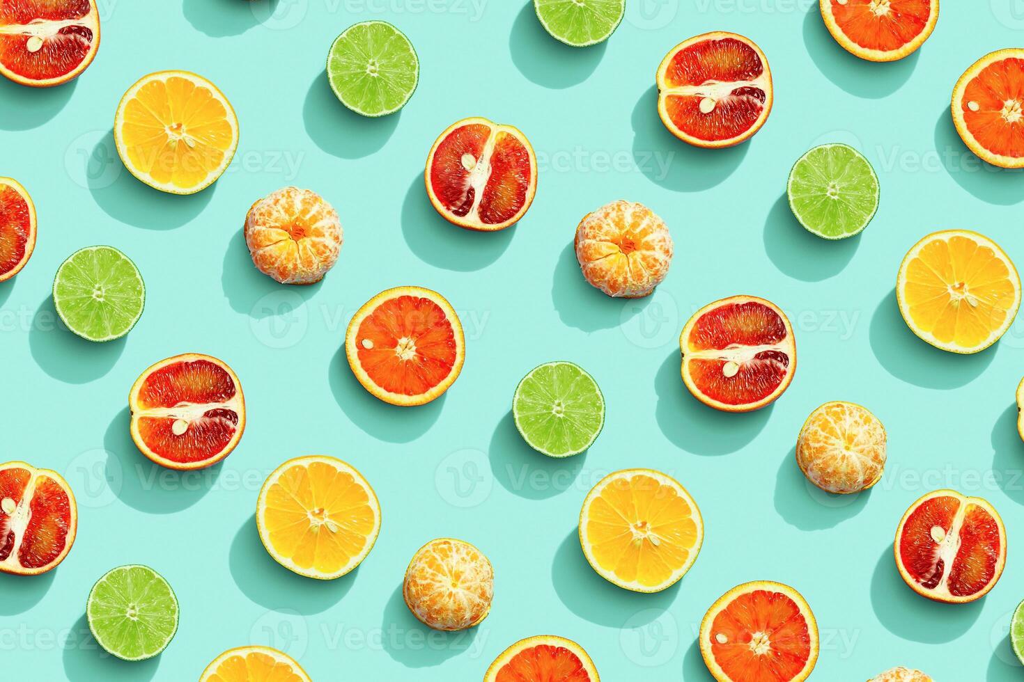 Citrus fruits as bring summer food pattern, grapefruit, orange, tangerine, lemon, lime, red orange with shadow at sunlight on mint background. Healthy fresh fruit food concept. Flat lay photo