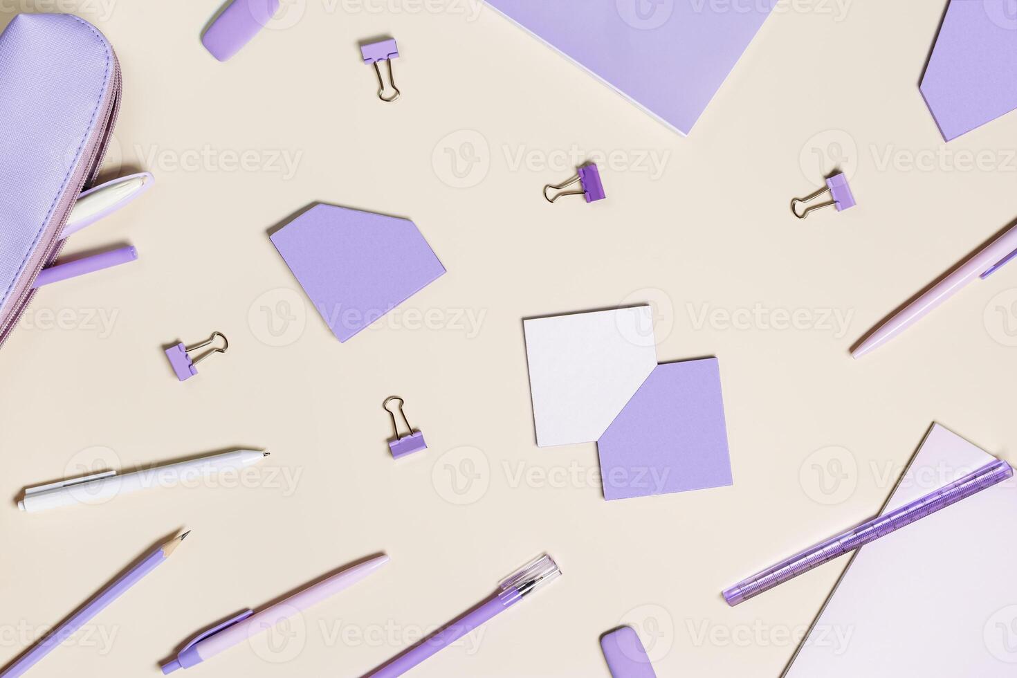 School stationery flat lay very peri trend color. Back to school concept, notebook, note, pen, paperclips on pastel beige background. Office equipment, view from above, minimal style photo
