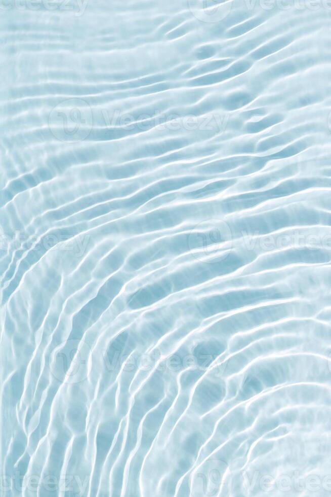 Clear blue water and waves at sunlight, sun flare and bright white reflections on blue, turquoise water surface. Summer vivid gradient color, graphic nature, dynamic aquatic ripples pattern, aesthetic photo