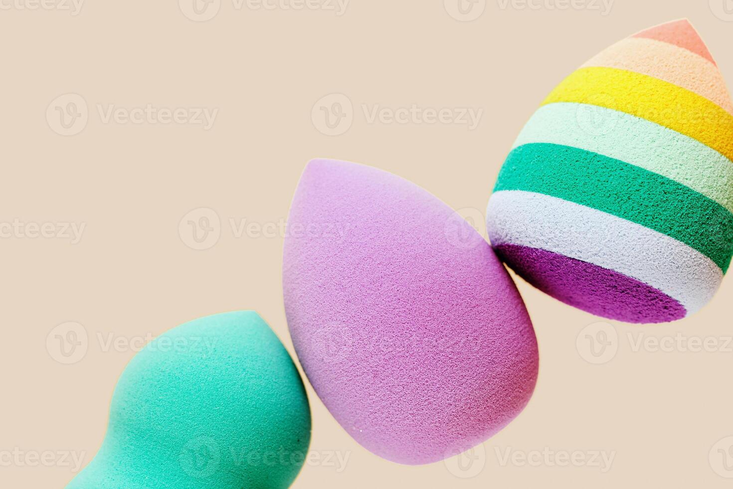 Colorful cosmetic beauty sponges different form Green, violet, rainbow colored make up tools for tone cream photo