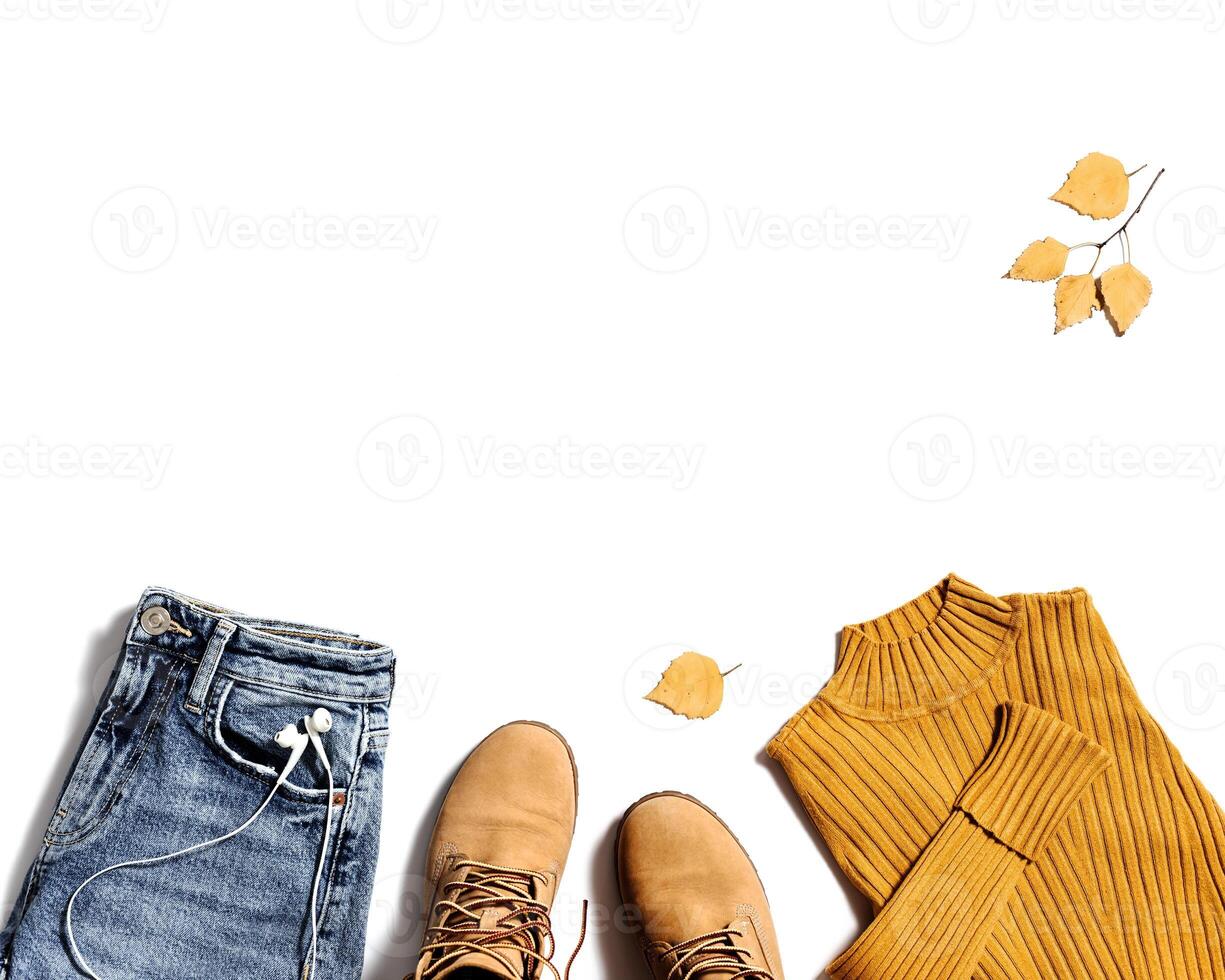 Autumn warm clothing, comfort red shoes, yellow sweater or turtleneck, blue jeans isolated on white. Female fashion autumnal outerwear photo
