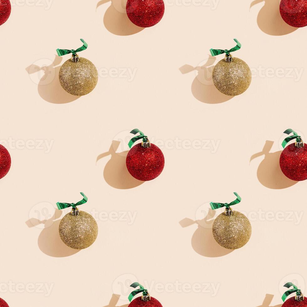 Happy holidays, Merry Christmas, New Year seamless pattern. Shiny red and golden Christmas balls or round baubles with shadows on pastel pink photo