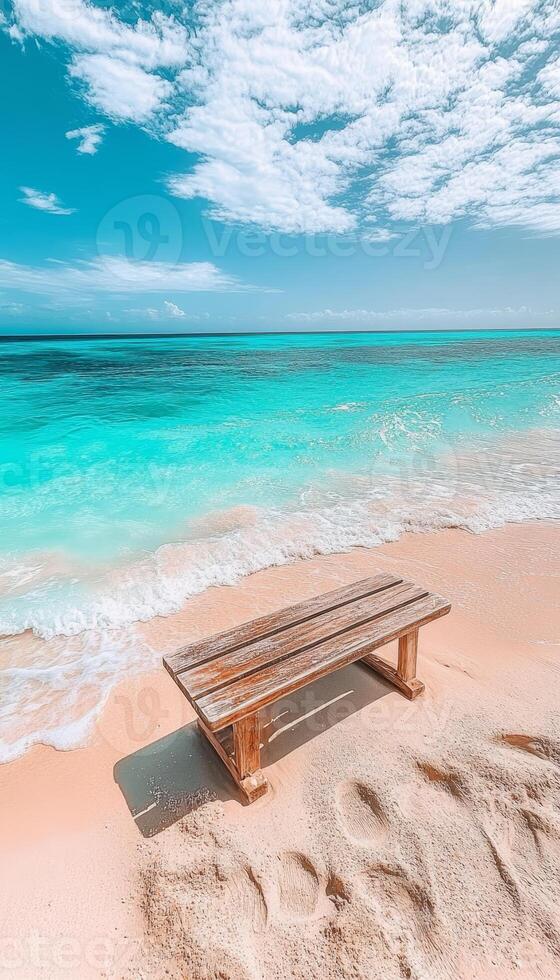 Wooden Bench Inviting Relaxation on a Serene Tropical Beach with Turquoise Water and Sky Views photo