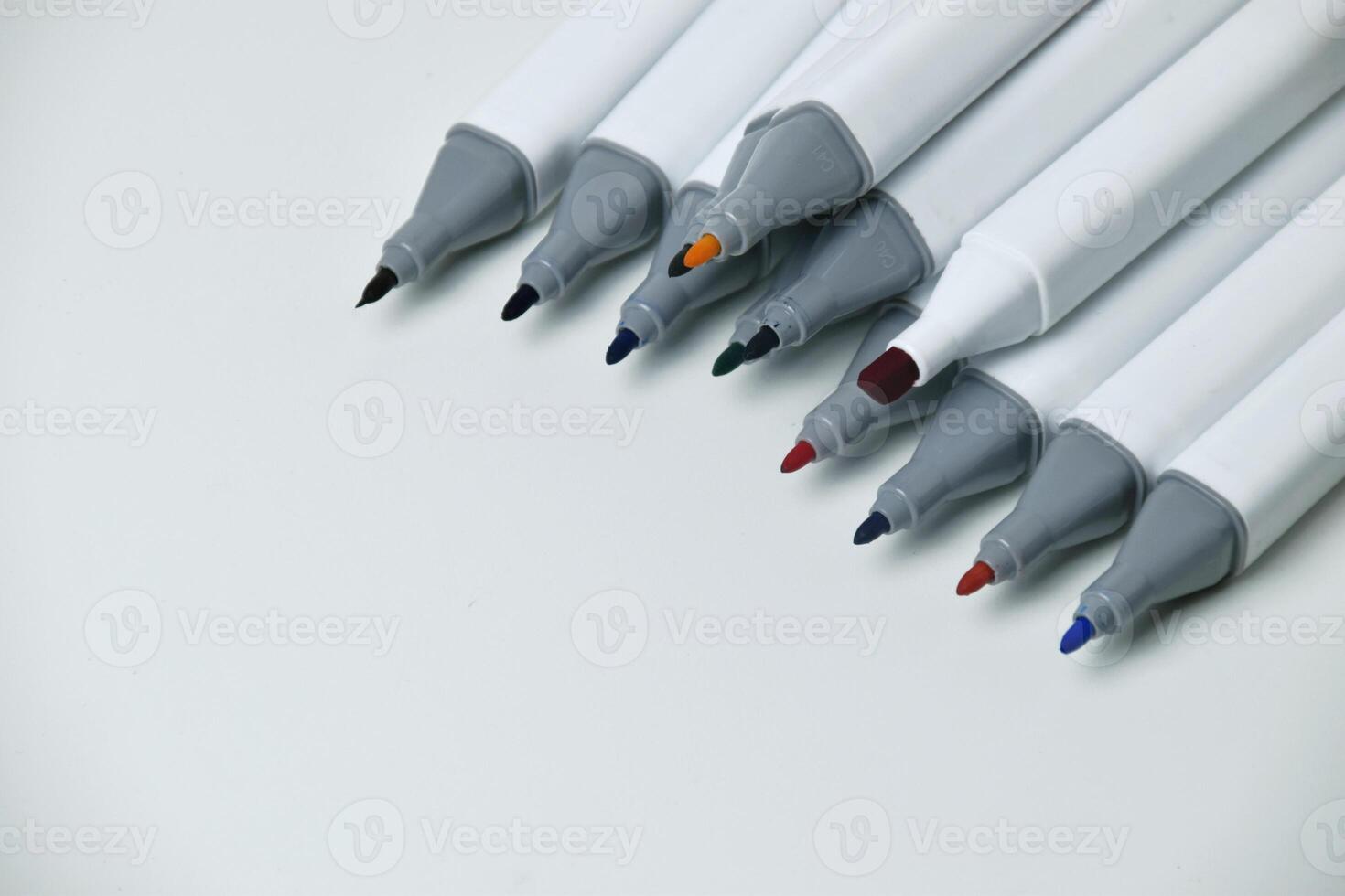 Top view of colorful markers with open caps photo