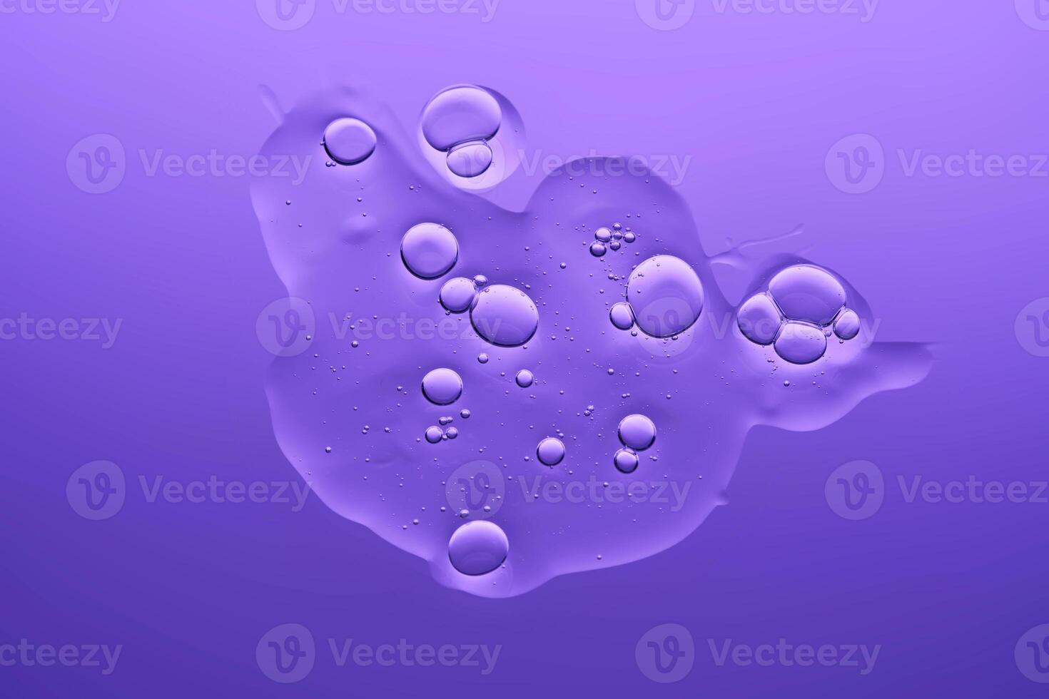 The texture of the serum on a purple background. photo