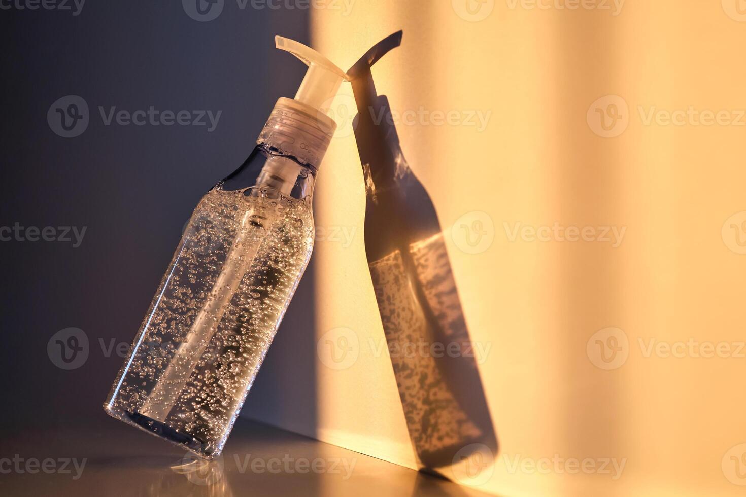 A tube of cosmetic gel or shower gel in the rays of the setting sun. photo