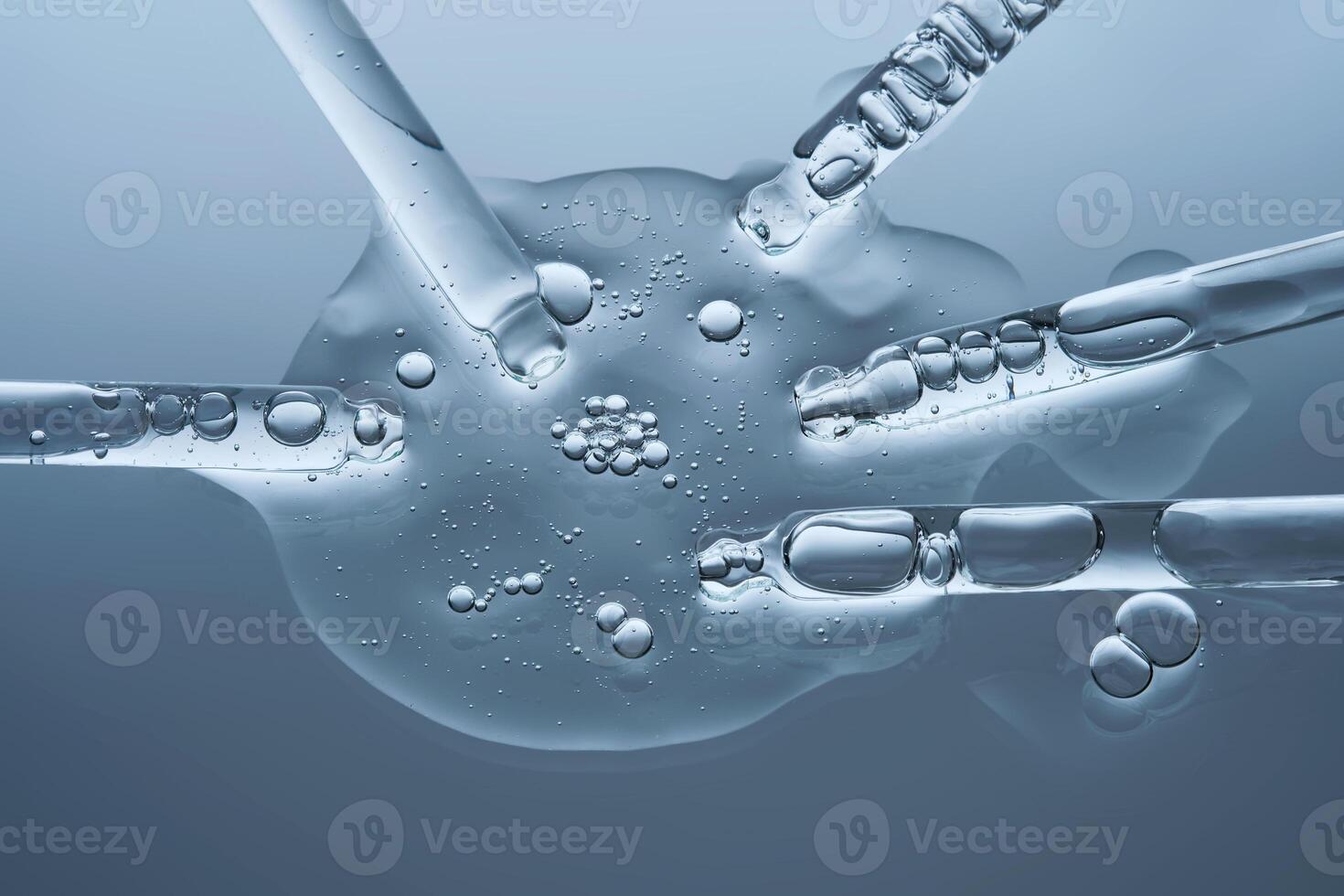 Facial serum and several pipettes on a blue background. The texture. photo