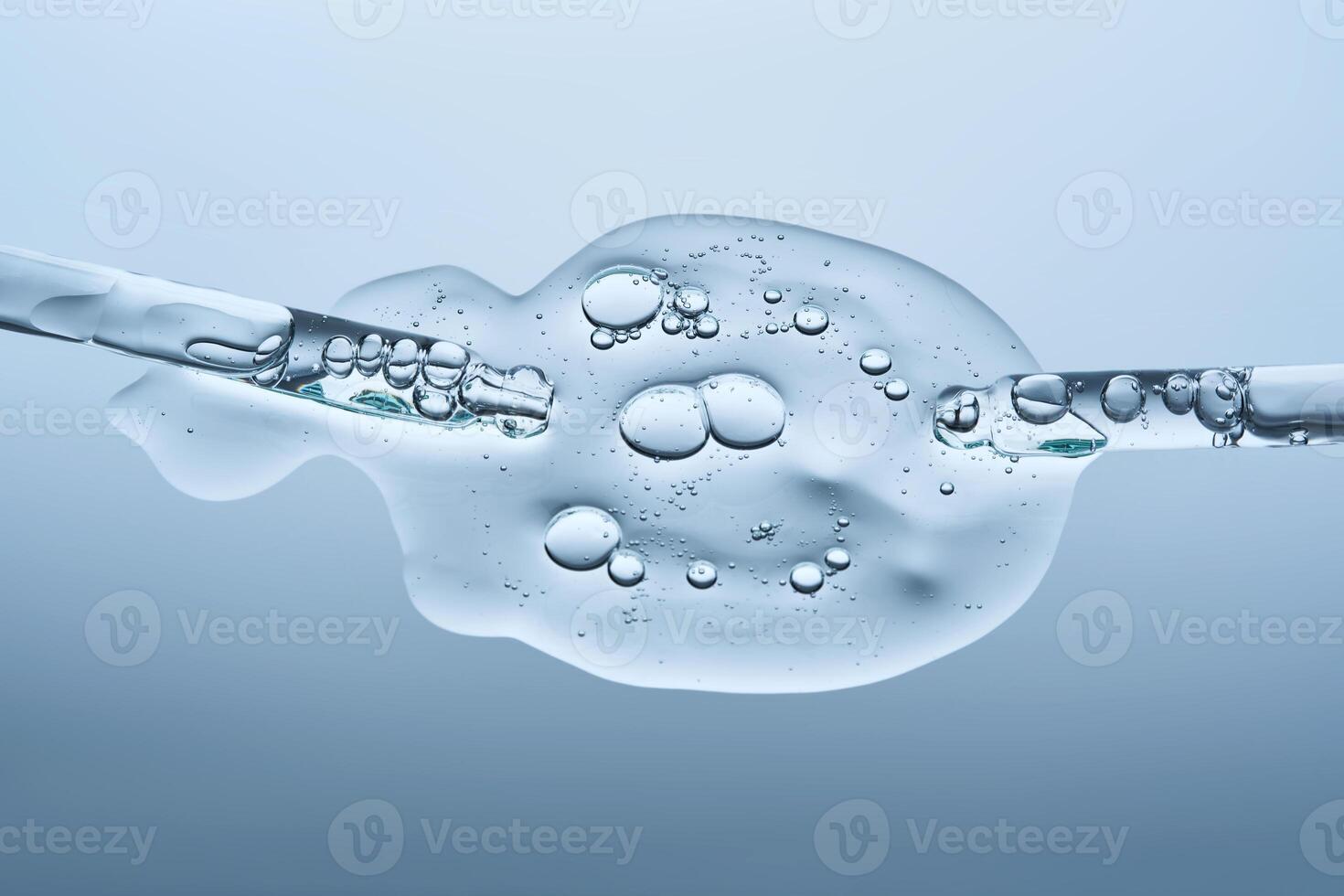 A facial serum with microneedles and two pipettes on a blue background. The texture. photo