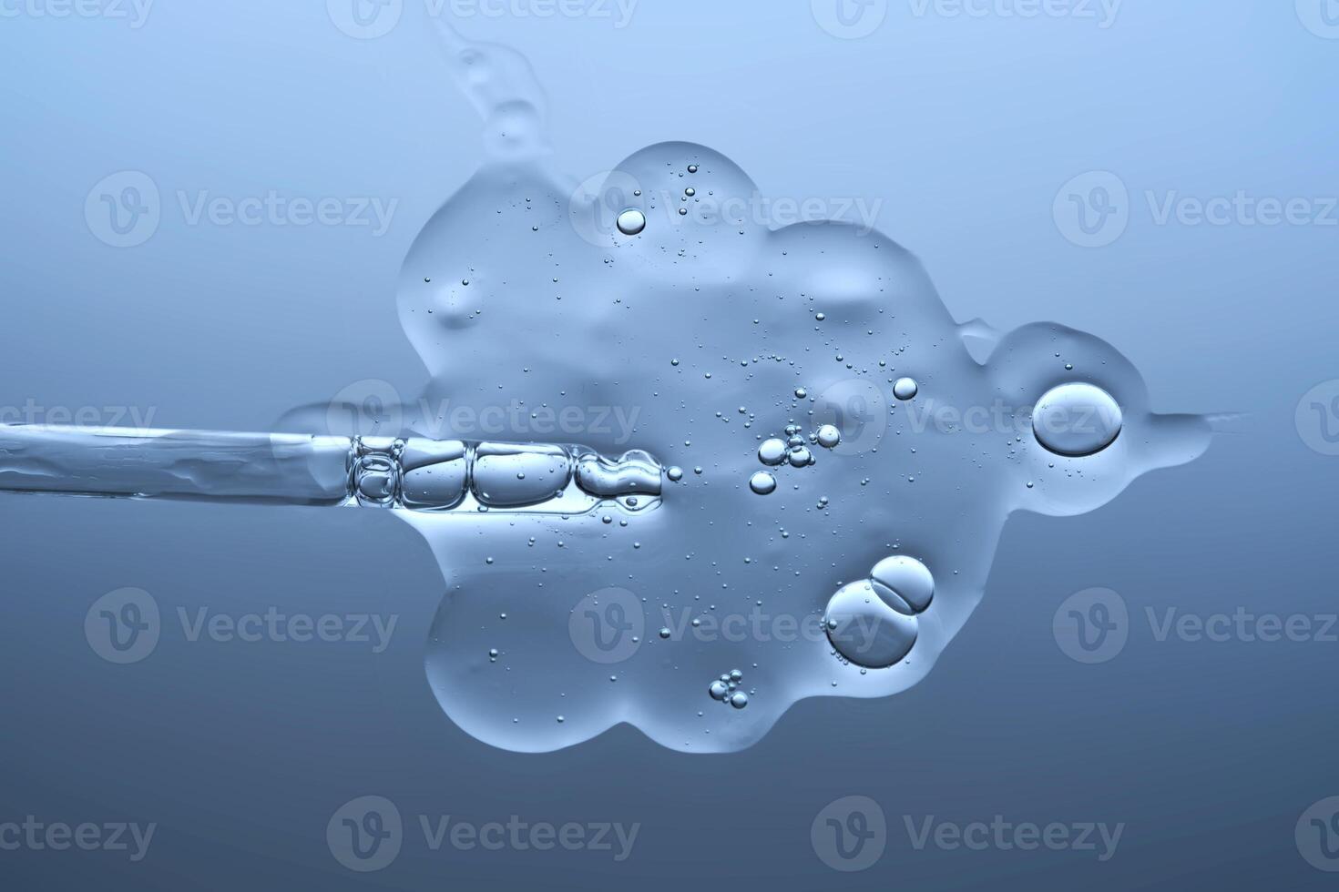 The texture of a serum with microneedles and a cosmetic pipette on a blue background. photo