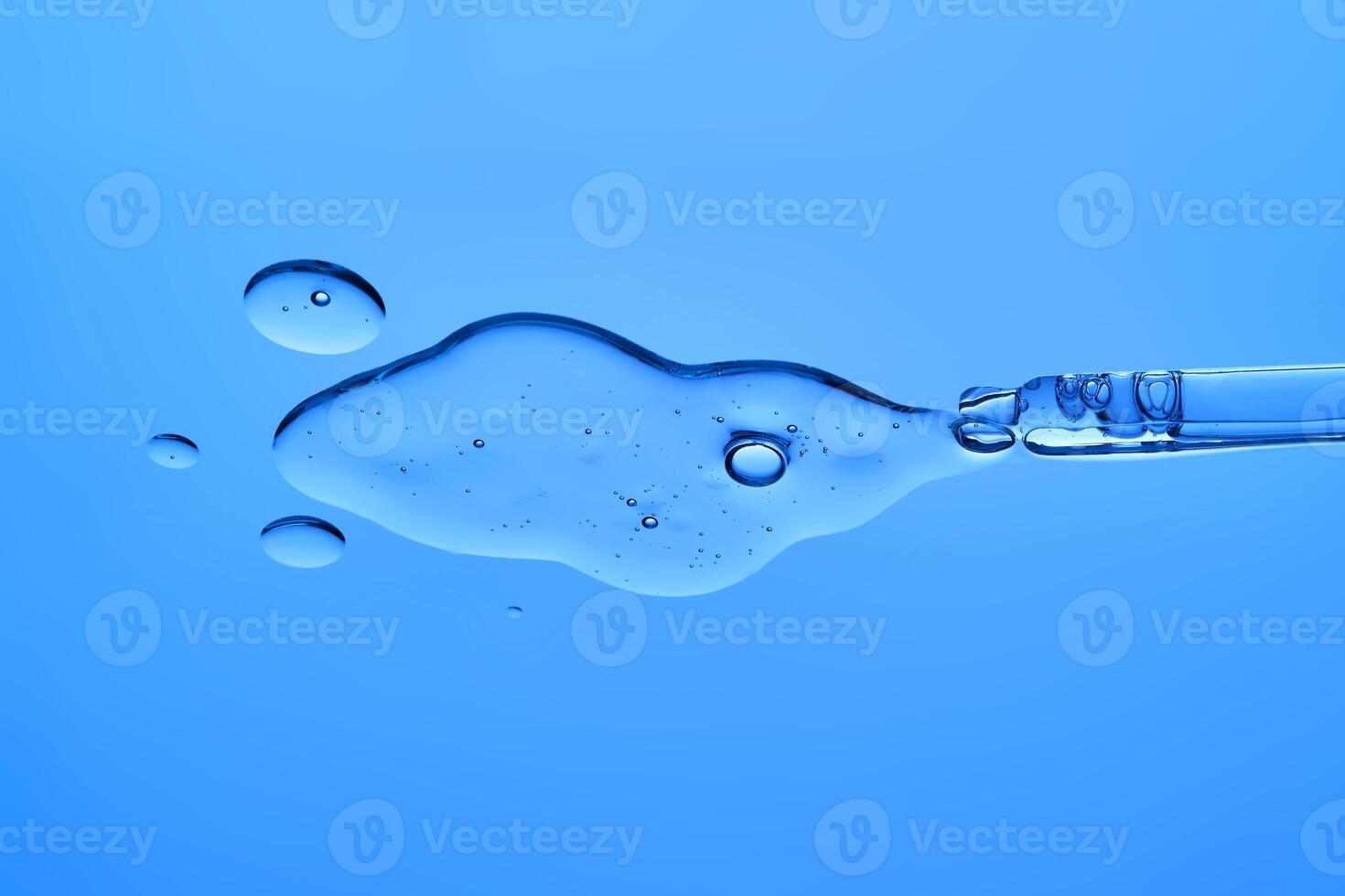 The texture of the moisturizing antiage serum on a blue background. photo