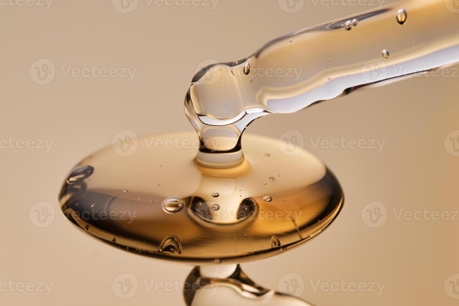 The serum pours from a pipette on a golden background. photo