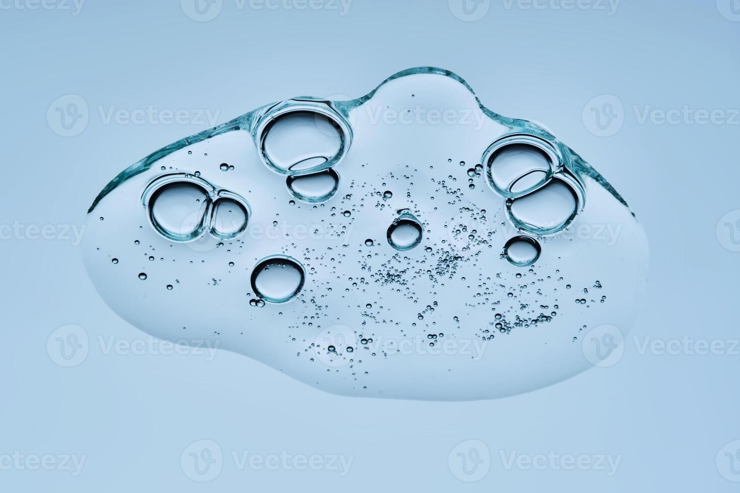 A drop of gel serum with bubbles. The texture. View from below. photo