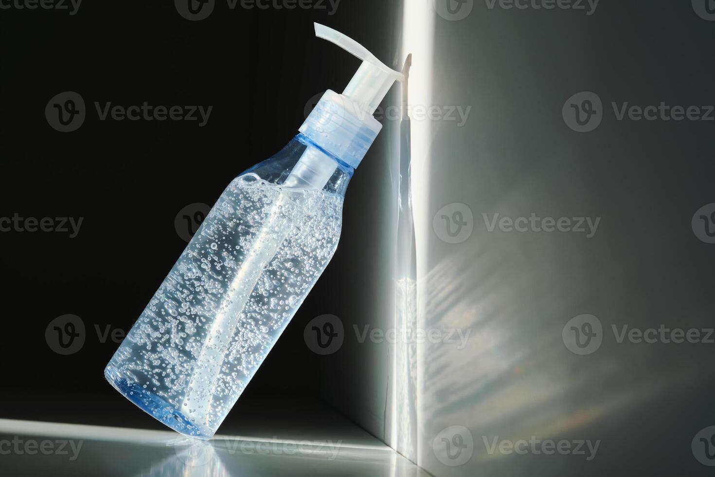 Tube of micellar gel in a ray of sunlight on a shadow background. photo