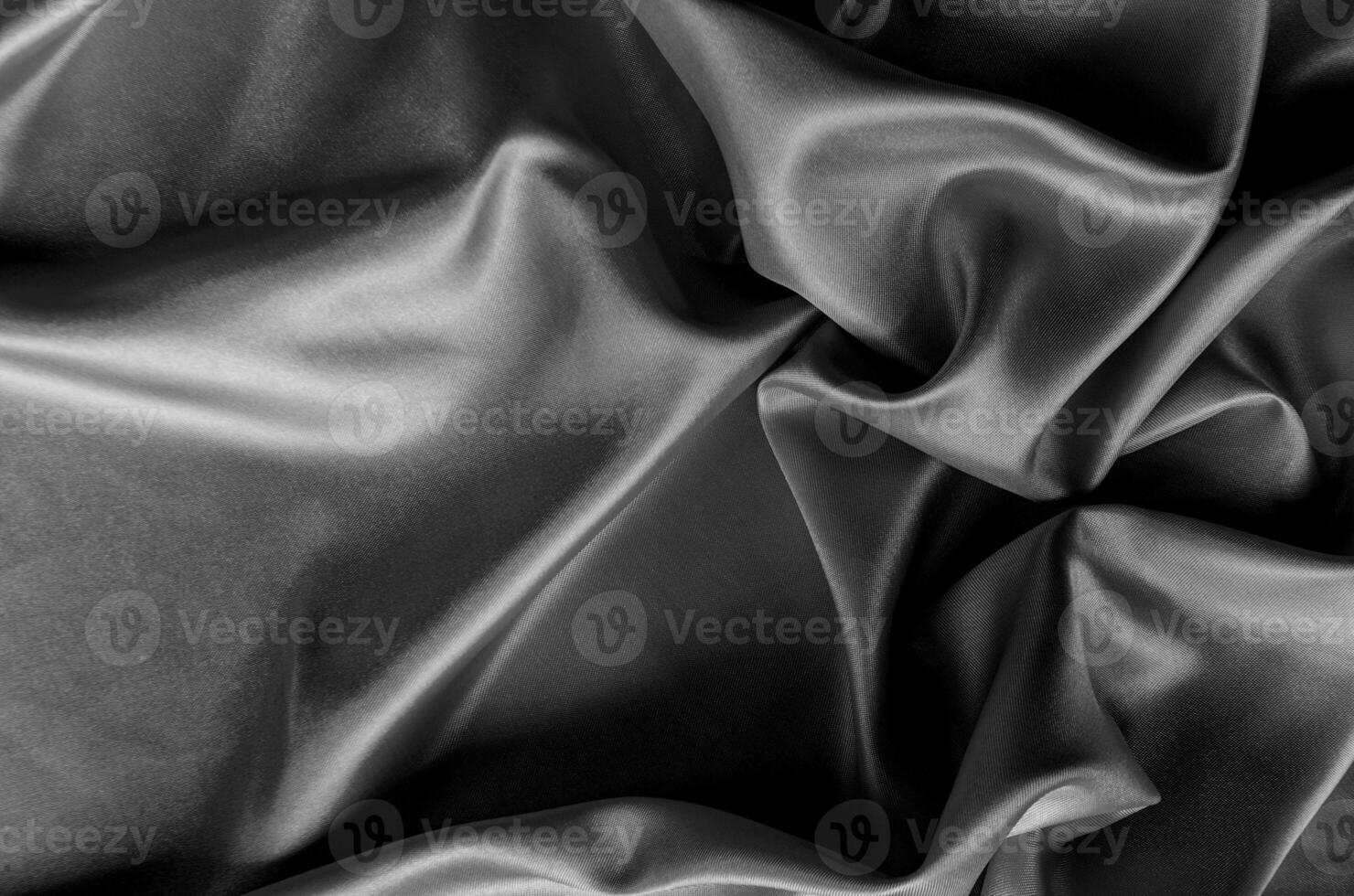 Top view of dark satin fabric with rich texture and smooth, elegant folds. Suitable for design and wallpaper background photo