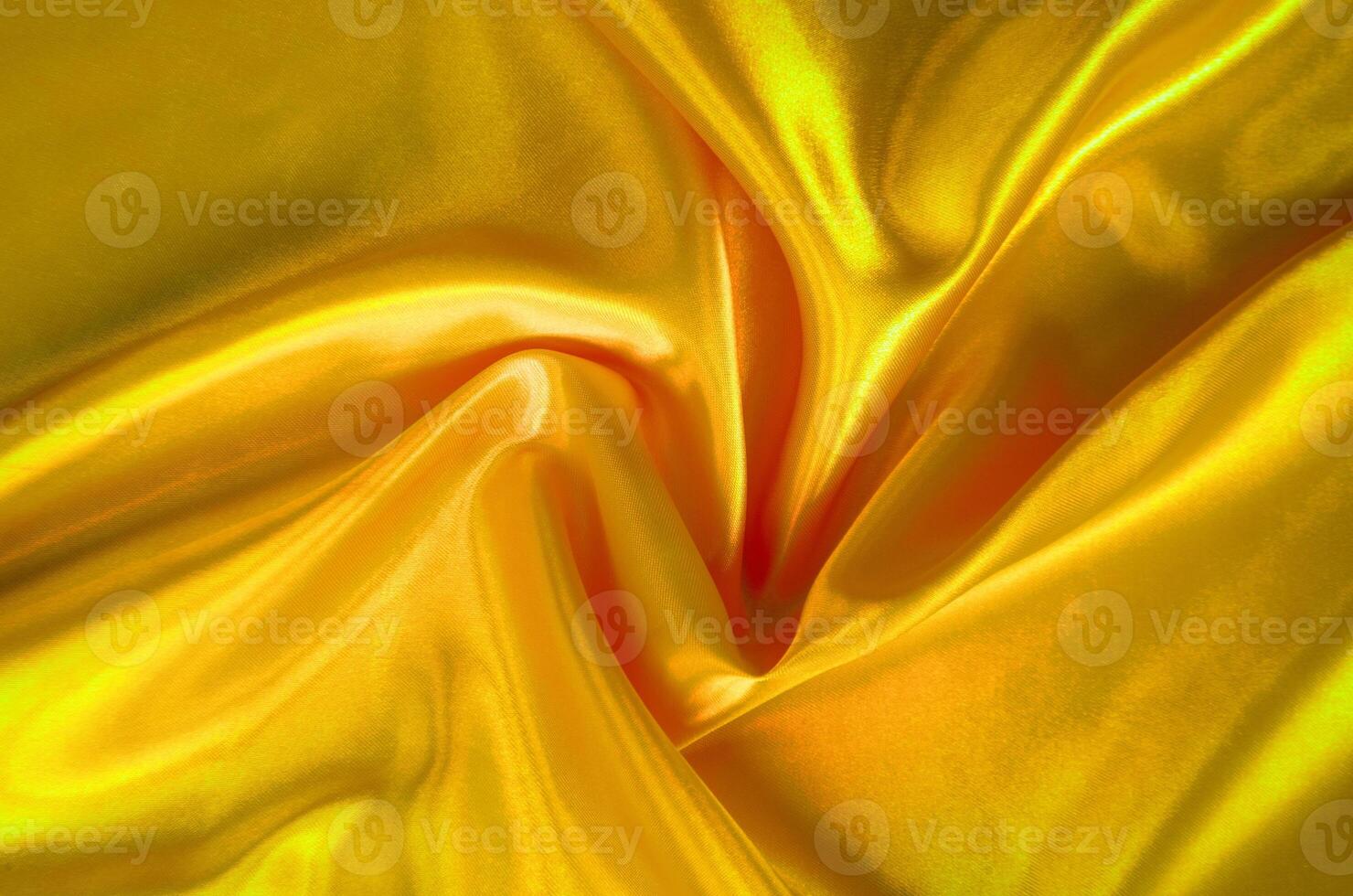 Golden yellow silk with soft curves and vibrant reflective surface. Suitable for design and wallpaper background photo