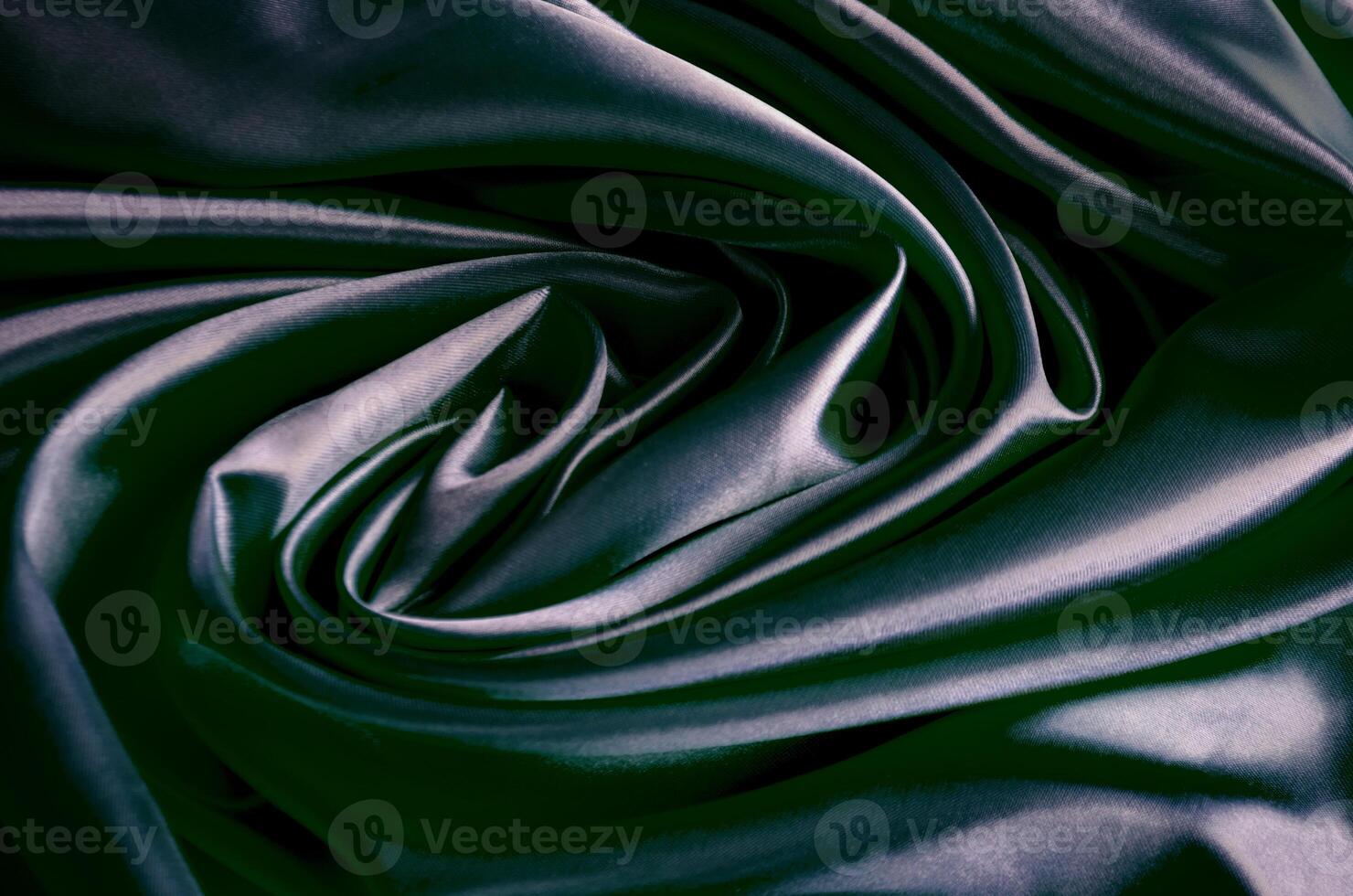 Top view of polished dark grey silk cloth with silky sheen and beautiful natural draping. Suitable for design and wallpaper background photo