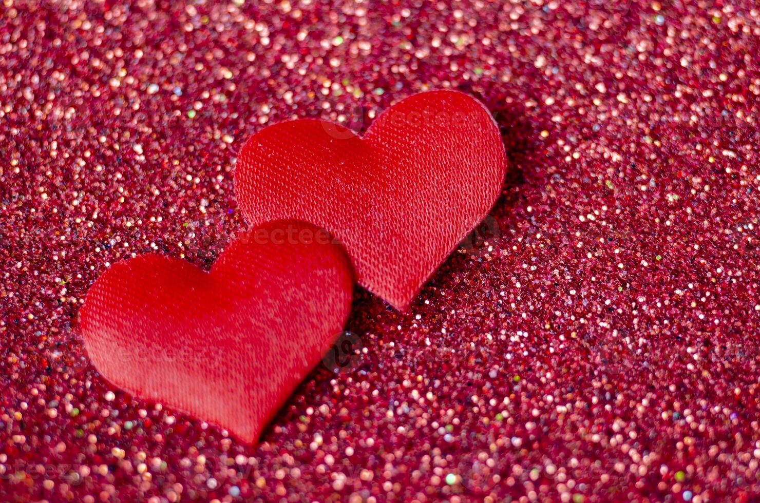 Tiny red hearts on sparkle red background with customizable space for text or wishes photo