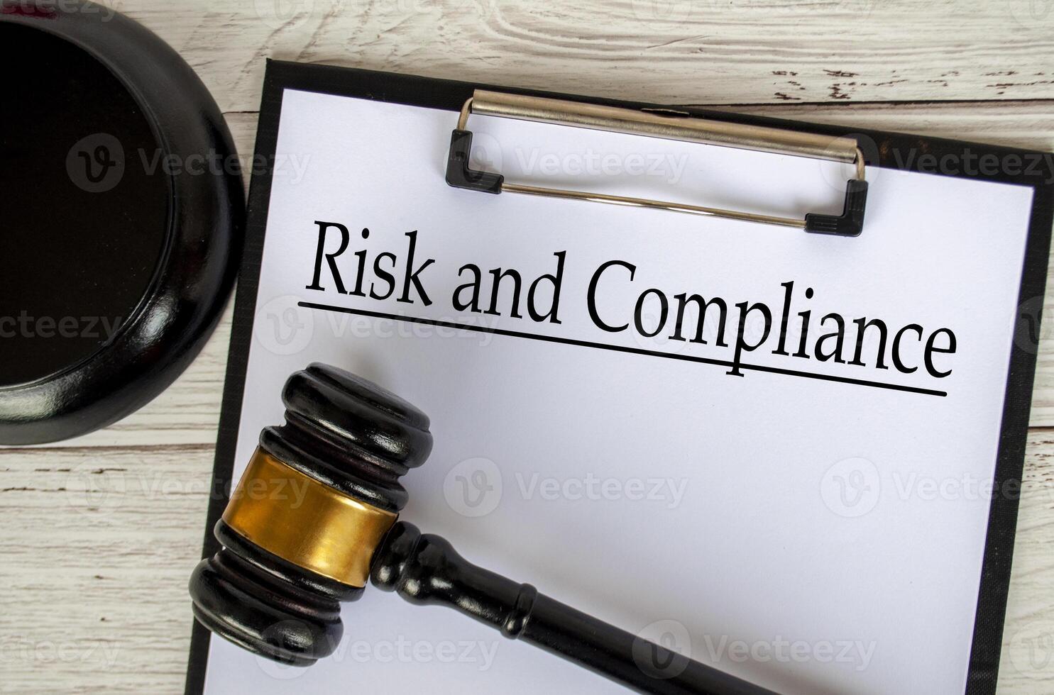 Top view of Risk and Compliance text on clipboard with gavel on top. Code of Conduct concept. photo