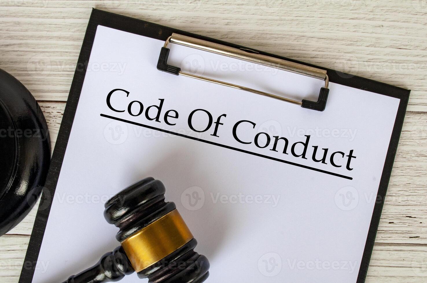 Top view of Code of Conduct text on clipboard with gavel on top. Code of Conduct concept. photo