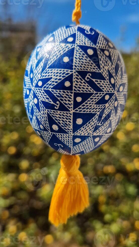 Exploring the beauty of Easter eggs with traditional Ukrainian pysanka designs showcasing intricate patterns in vibrant blue against a sunny background photo