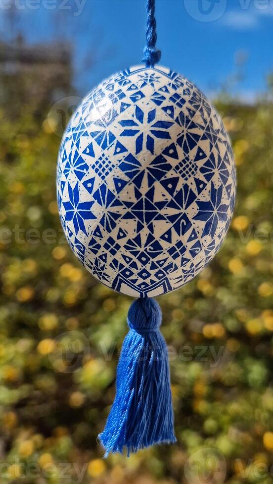 Ukrainian pysanka decorated with traditional patterns represents the beauty of Easter eggs in a vibrant spring setting photo