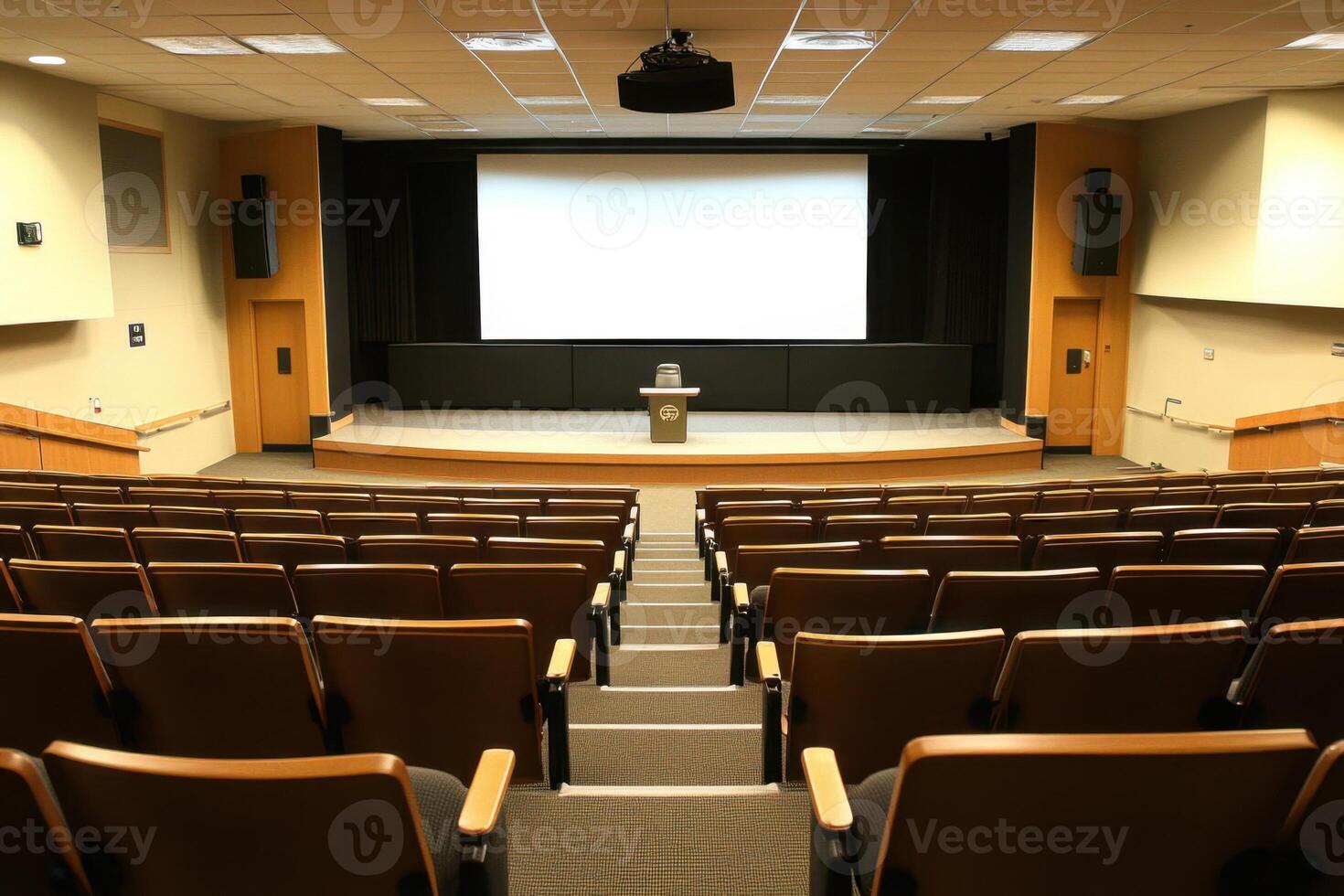 a large auditorium with empty seats and a projector screen photo