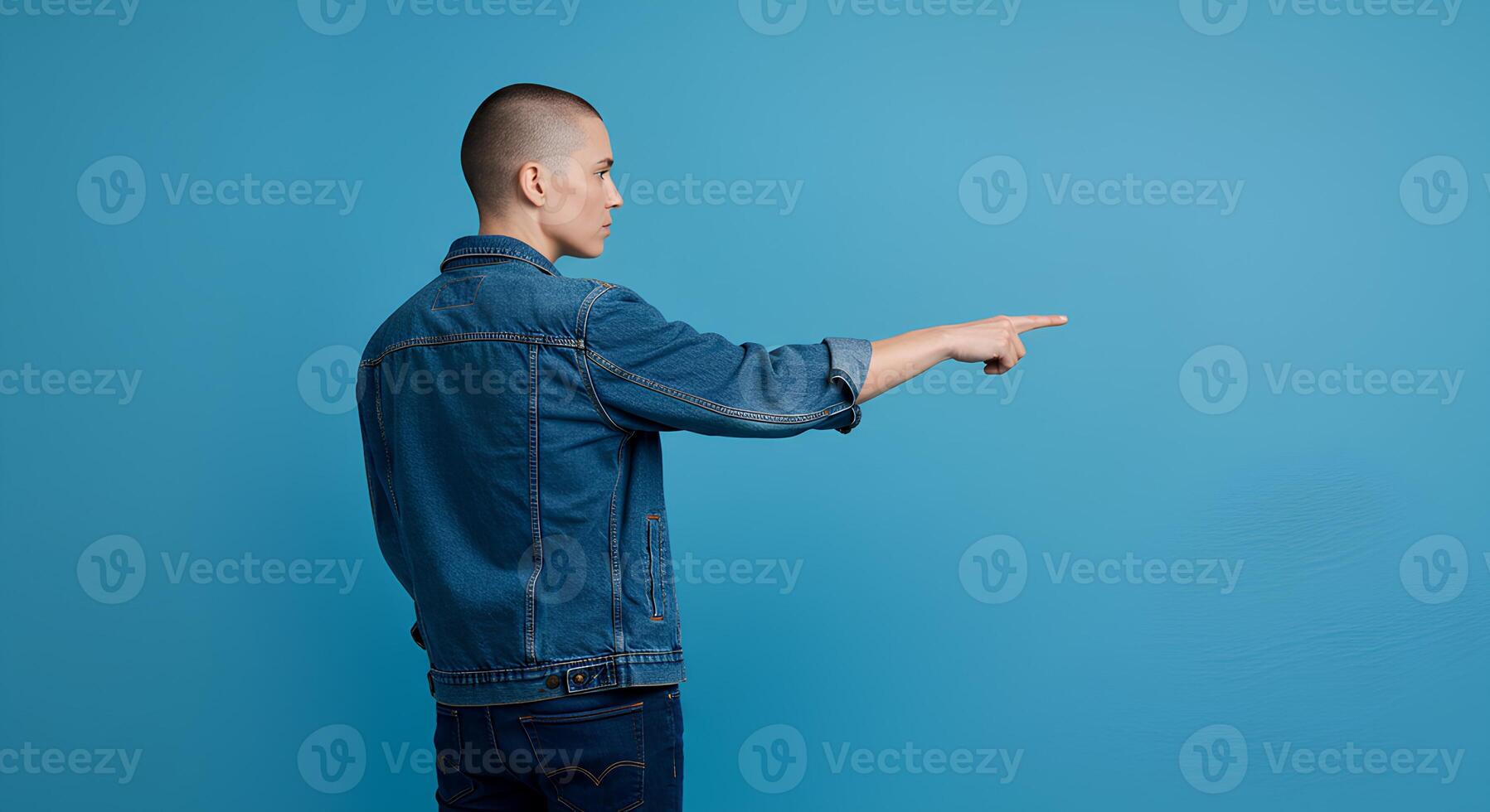 Person in Denim Jacket Pointing, Studio Portrait photo