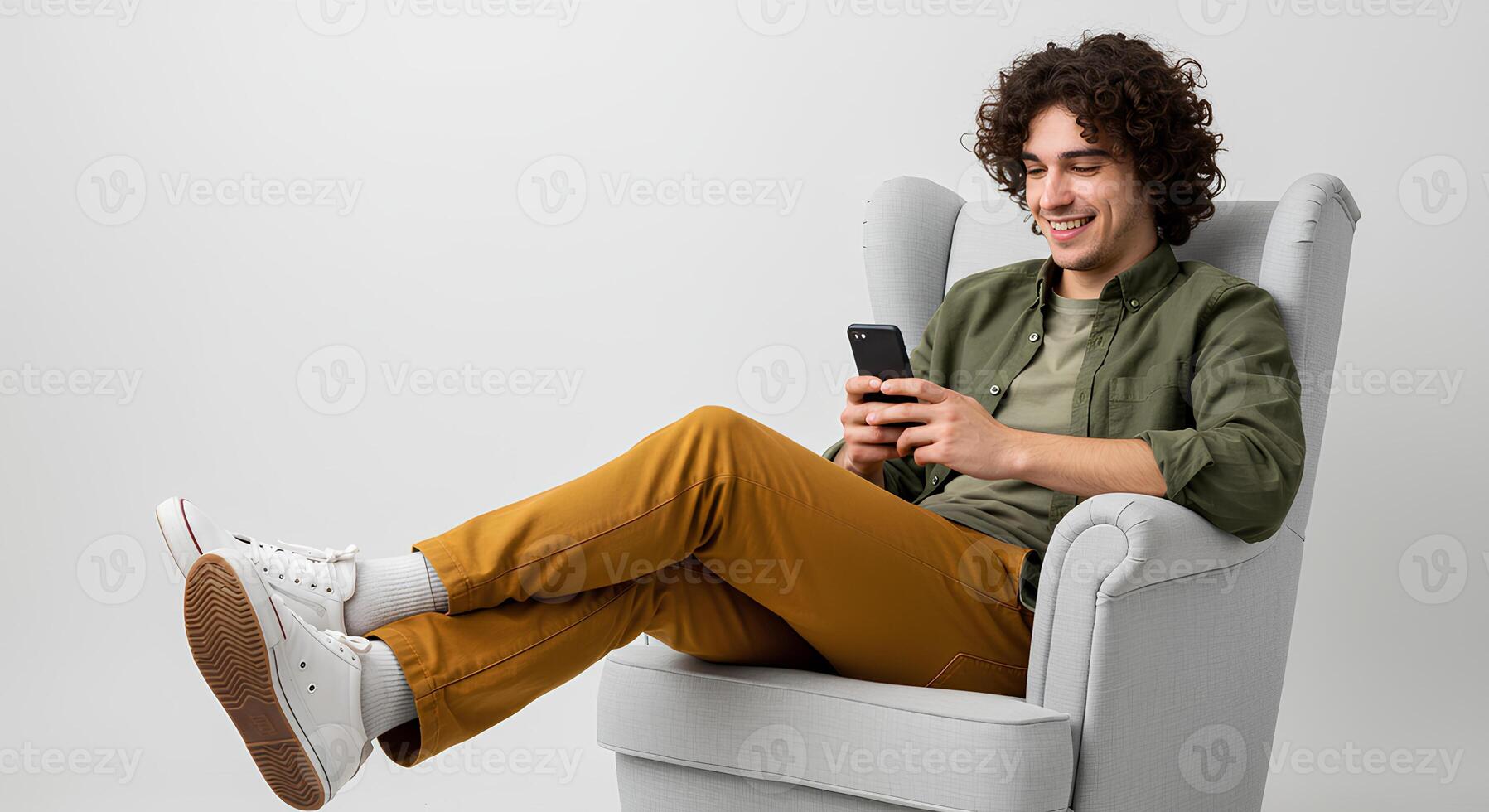 Relaxed Man Using Smartphone in Armchair photo