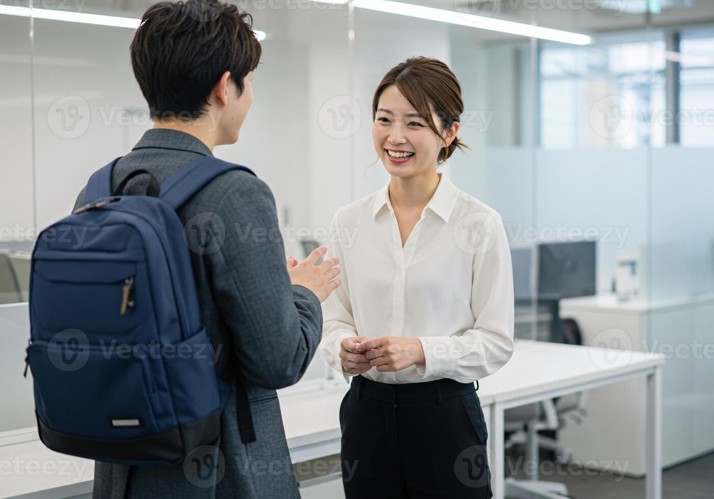 Two colleagues talking in a modern office environment photo