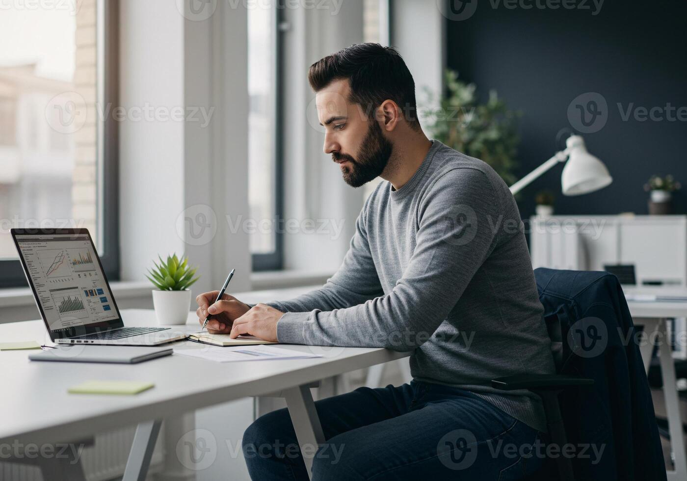 Focused Professional Analyzing Data on Laptop in Modern Office photo
