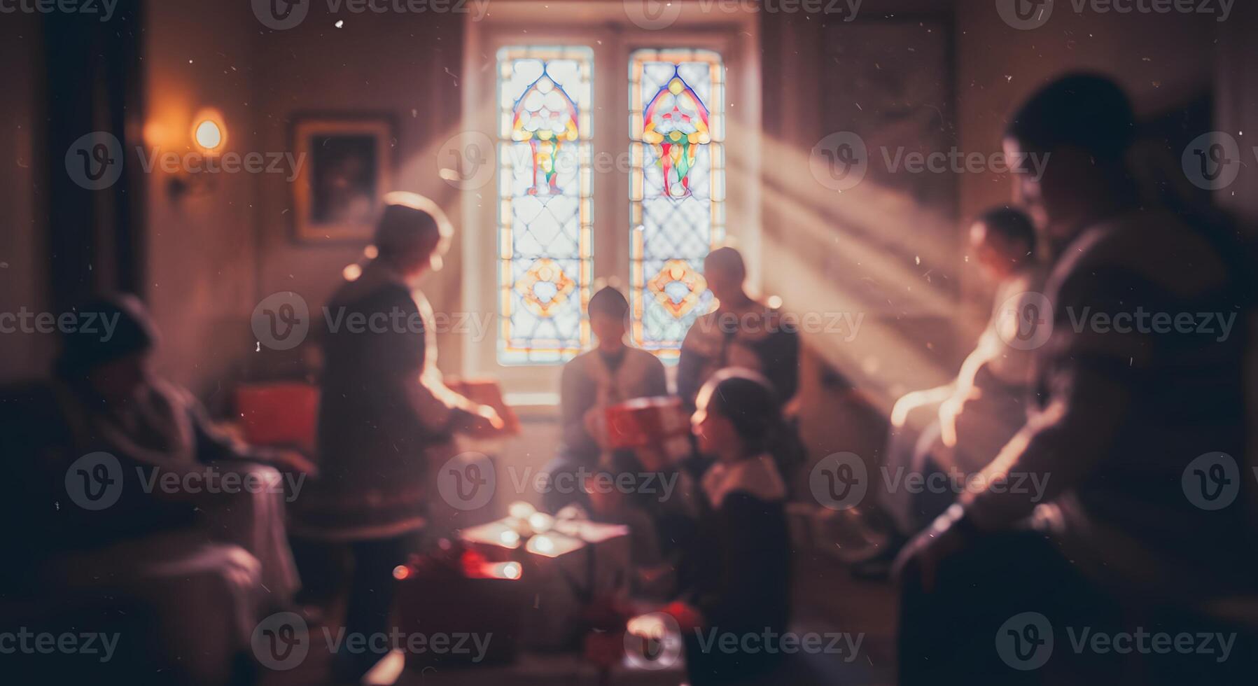 A group of people sitting around a table in front of a stained glass window photo