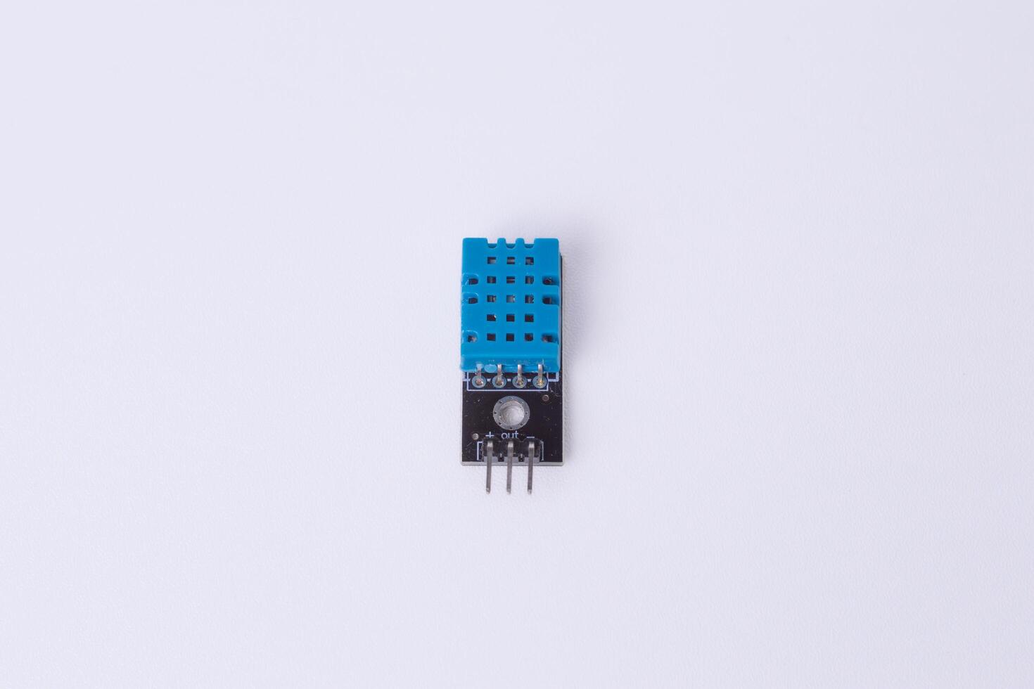 Malang, March 24, 2025. Front view of DHT11 temperature and humidity sensor module. Digital sensor for Arduino, IoT projects, weather monitoring, home automation. White background. photo