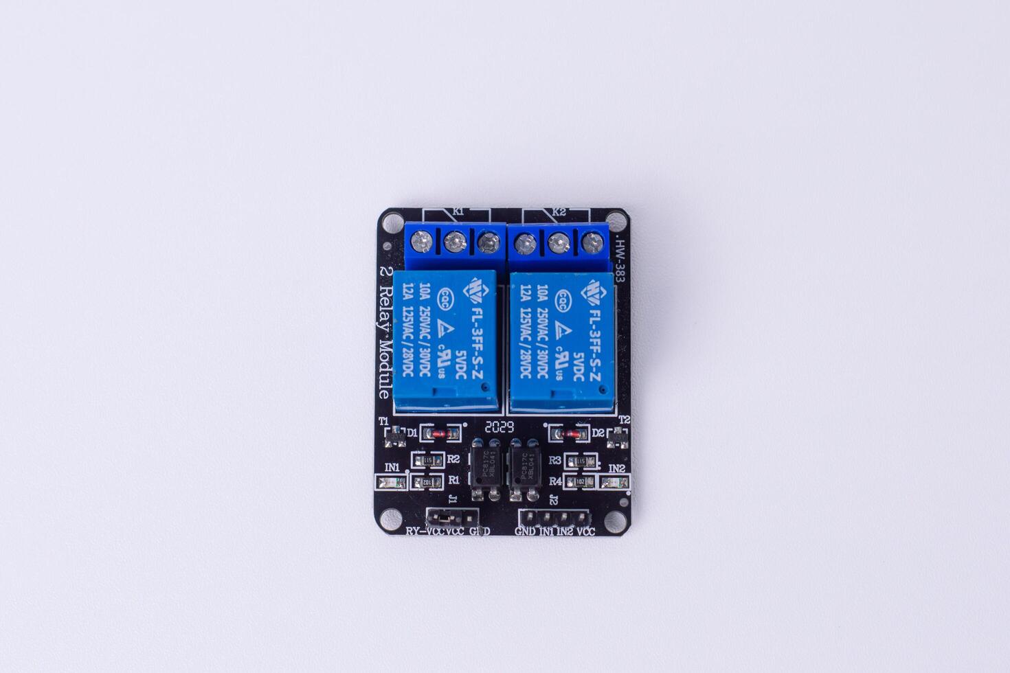 Malang, March 24, 2025. Top view of 2 channel relay module for Microcontroller. 5V control board for smart home automation, IoT projects, electronic switching. White background. photo