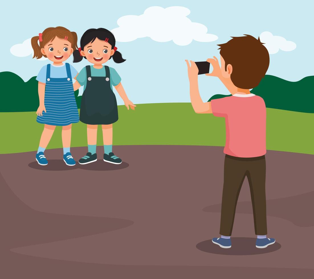 Cute little boy taking a photograph of girl friends using smartphone in the park vector