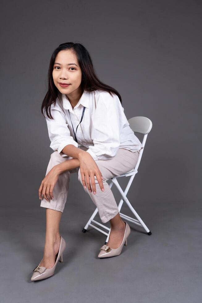 Full Body Portrait of Young Woman Posing with Chair Isolated Background photo