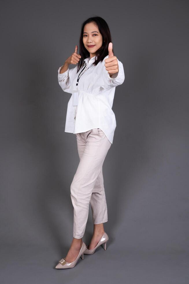 Full Body Portrait of Young Confident Female Thumbs Up in Approval or Recommendation photo
