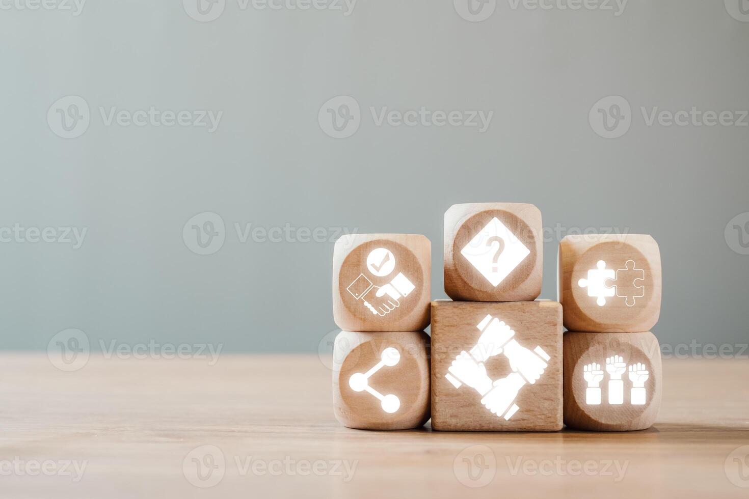 Wooden blocks with partnership symbols representing teamwork, collaboration, and connection on a wooden table. photo