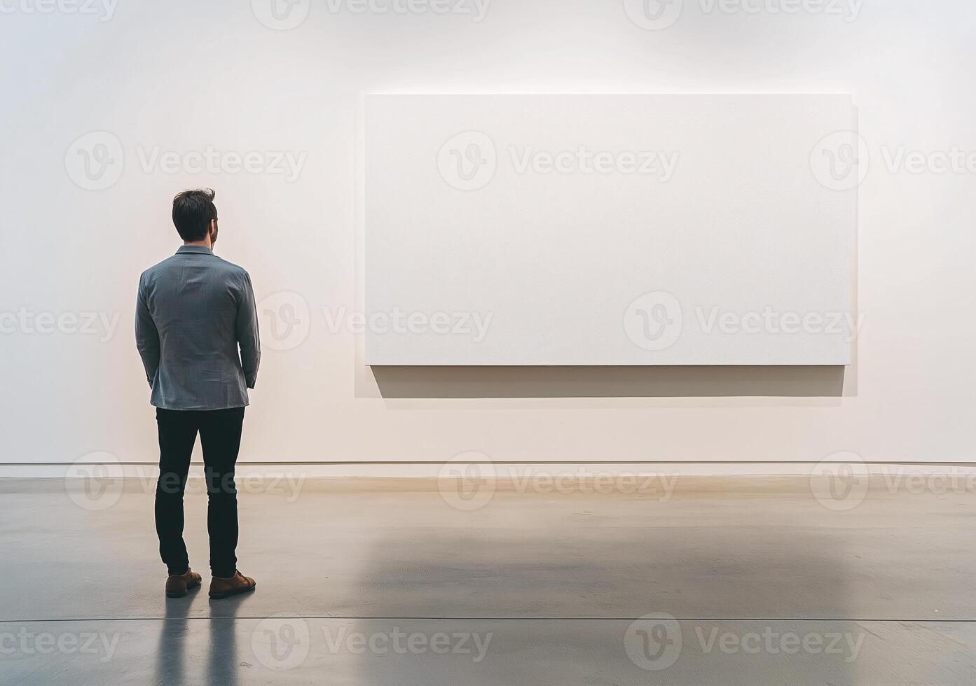 A man stands in front of a large white wall photo
