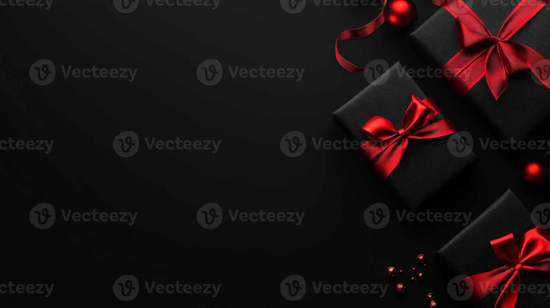 Three black boxes with red bows on top of a black background photo