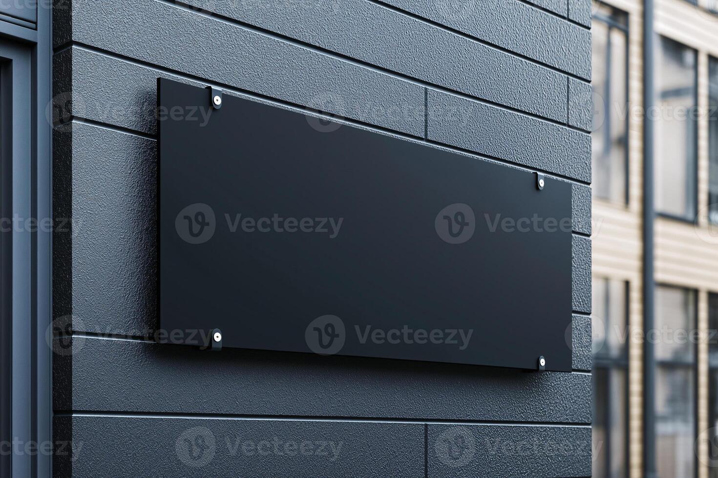 A black sign is on a wall photo