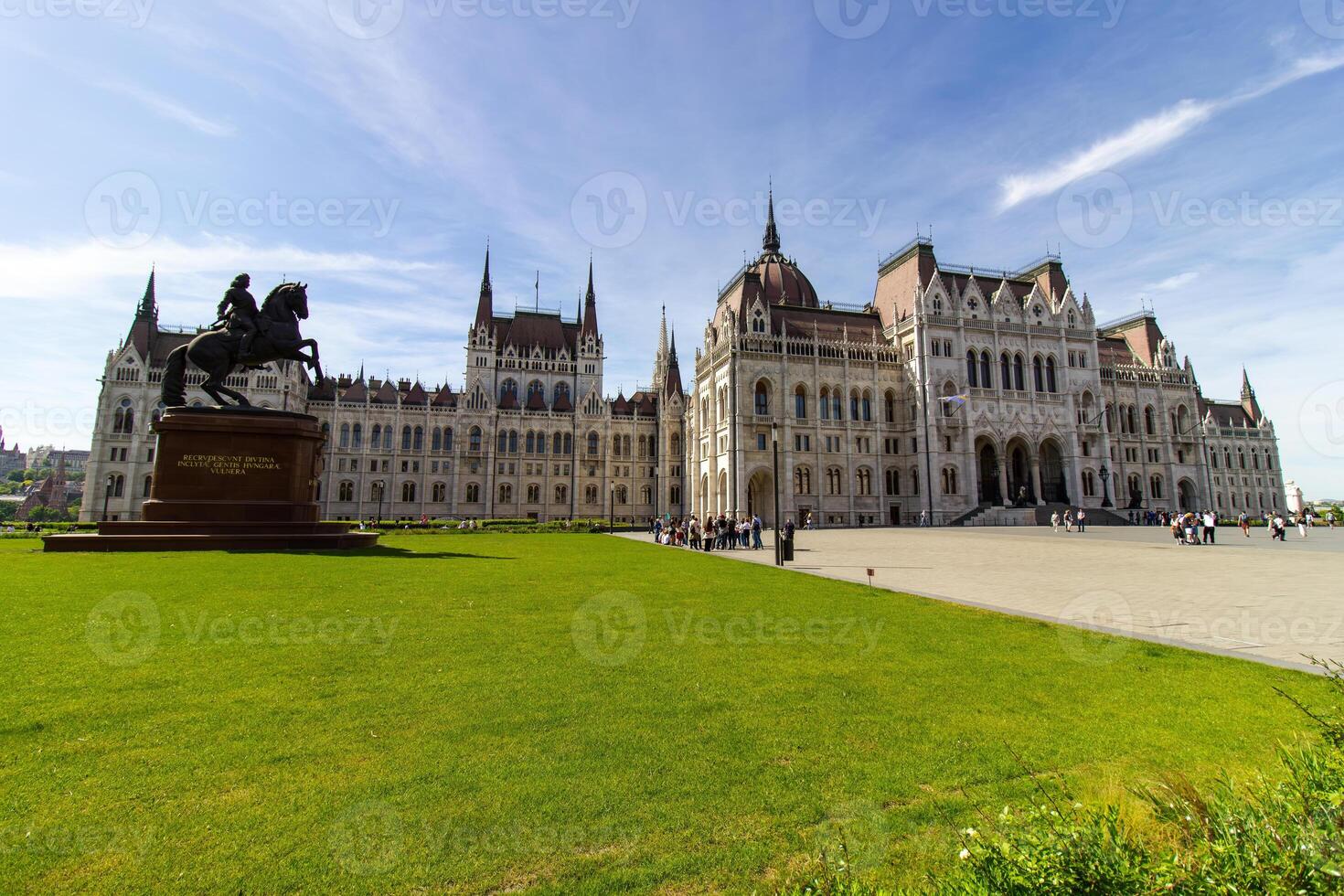 Hungarian Parliament Building with tourists on a sunny day in Budapest, photographed on April 14, 2024. Neo-Gothic architecture and travel landmark photo