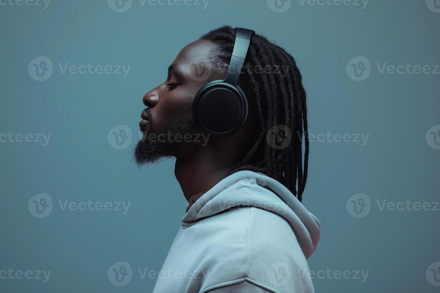 A man with dreadlocks listening to music photo