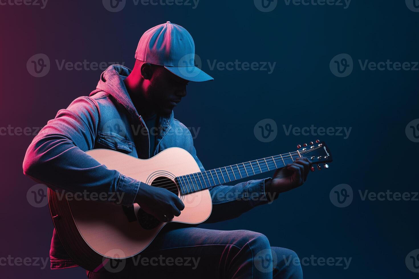 Man in a hat playing guitar on a blue background photo