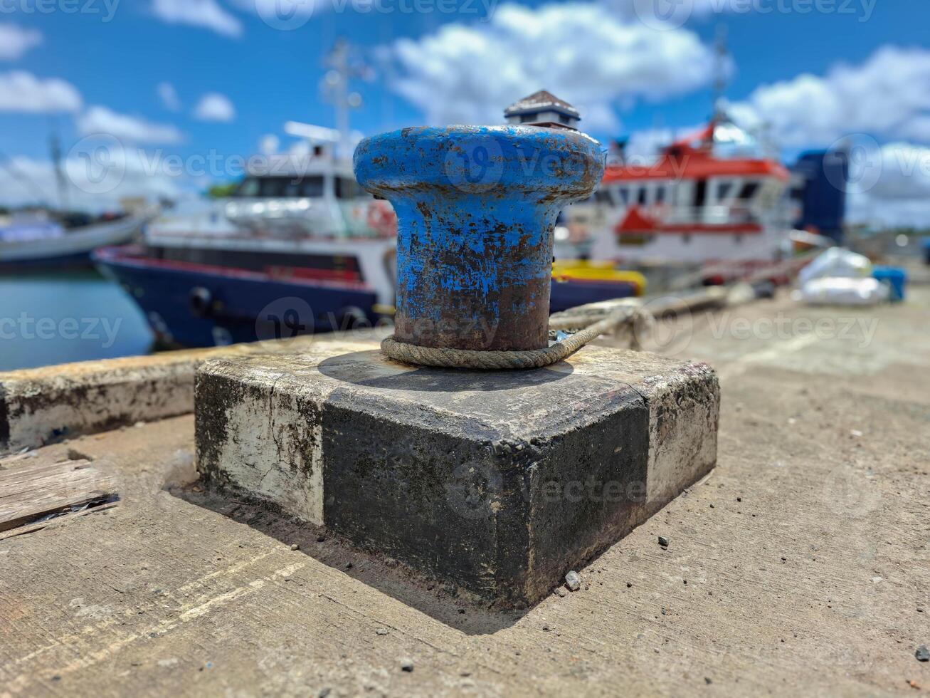 Mooring bollard with rope to tie the ship when docked photo